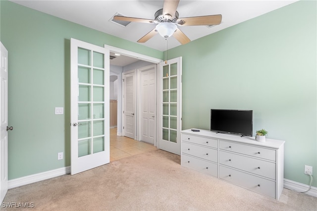 13104 Silver Thorn Loop, North Fort Myers, FL 33903 - bedroom featuring french doors, light carpet, baseboards, and ceiling fan