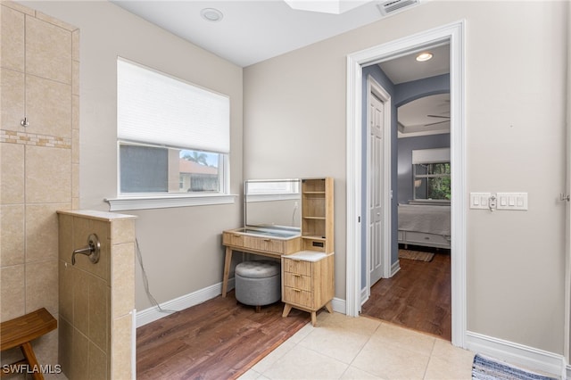 13104 Silver Thorn Loop, North Fort Myers, FL 33903 - full bath featuring a walk in shower, wood finished floors, baseboards, and ensuite bath