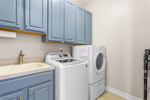 13104 Silver Thorn Loop, North Fort Myers, FL 33903 - laundry room with washer and clothes dryer, cabinet space, baseboards, and light tile patterned flooring