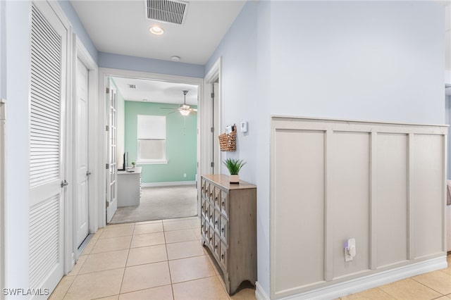 13104 Silver Thorn Loop, North Fort Myers, FL 33903 - corridor featuring light tile patterned floors and light colored carpet