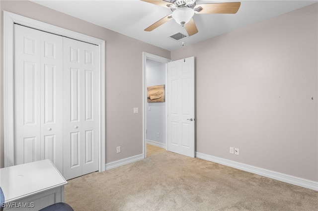 13104 Silver Thorn Loop, North Fort Myers, FL 33903 - unfurnished bedroom featuring light colored carpet, a closet, baseboards, and a ceiling fan