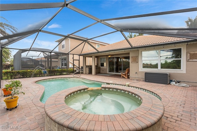 13104 Silver Thorn Loop, North Fort Myers, FL 33903 - view of pool featuring a patio, a ceiling fan, a pool with connected hot tub, and glass enclosure