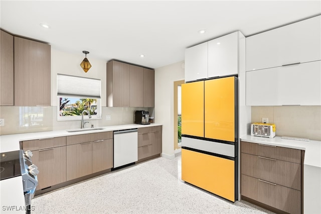 kitchen with freestanding refrigerator, electric range oven, a sink, dishwasher, and tasteful backsplash