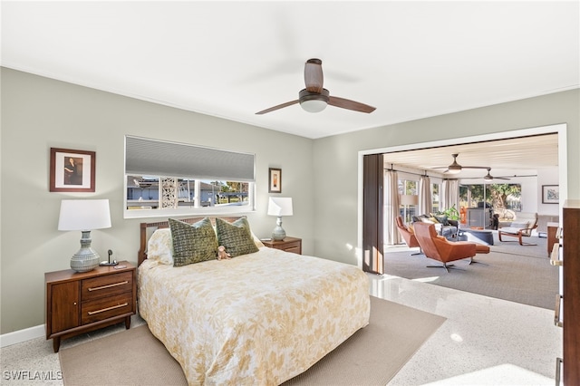 carpeted bedroom with a ceiling fan and baseboards