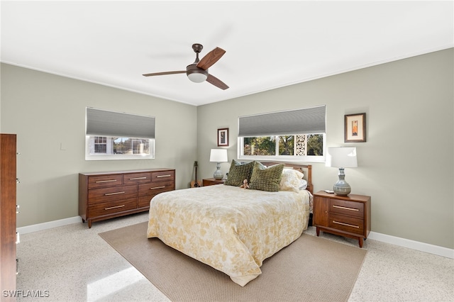 bedroom featuring baseboards, speckled floor, and ceiling fan