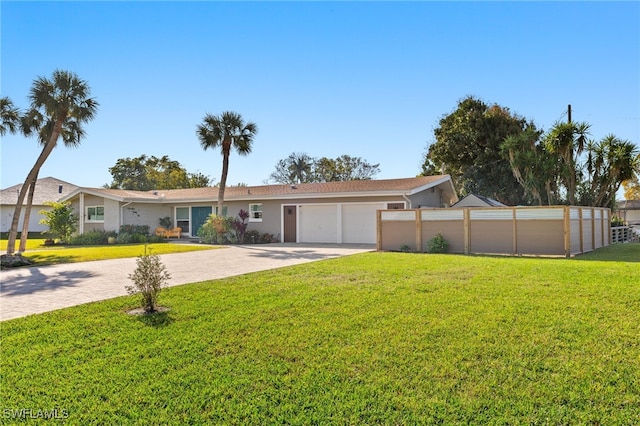 ranch-style home with stucco siding, a front lawn, driveway, fence, and a garage