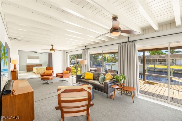 sunroom with beamed ceiling and a ceiling fan