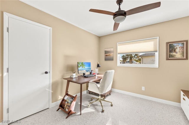 office area with a ceiling fan and baseboards