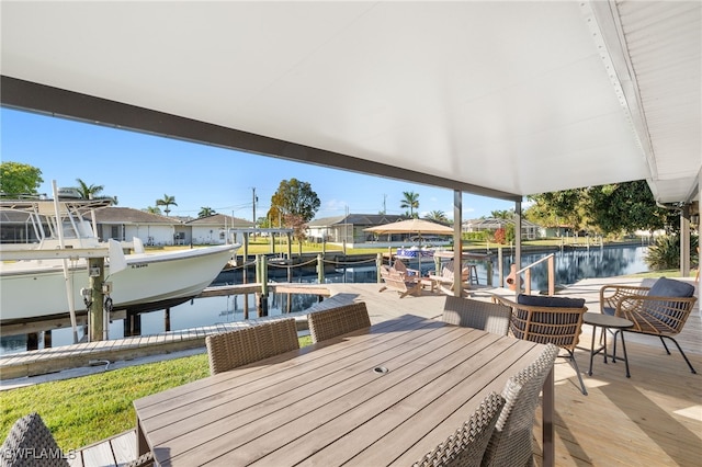 view of patio / terrace featuring a boat dock, a water view, a residential view, and boat lift