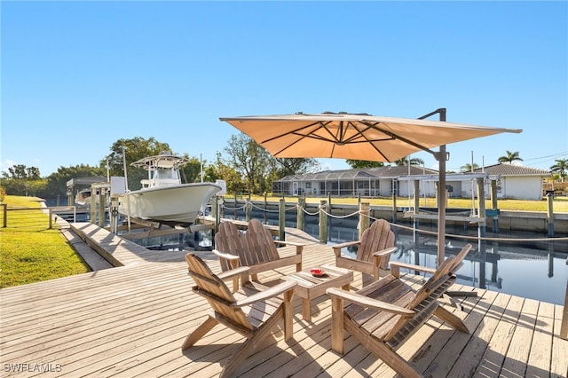 dock area with a water view and boat lift