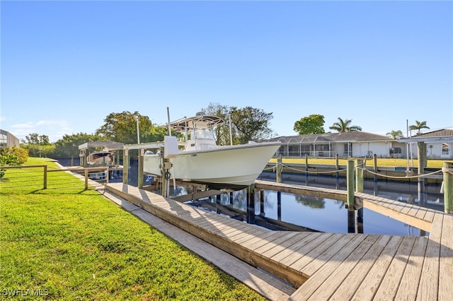 dock area with a yard, a water view, and boat lift