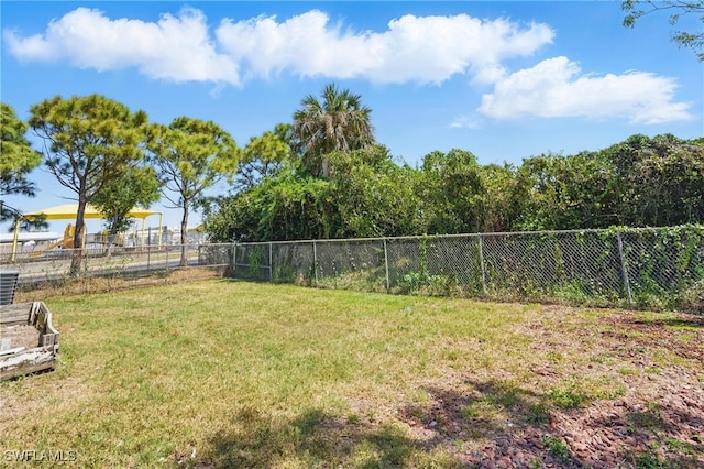 view of yard featuring a water view and fence