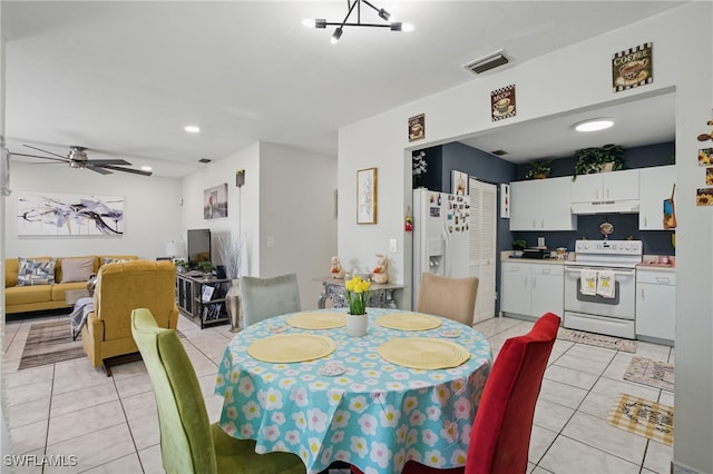 dining room with light tile patterned floors, visible vents, and a ceiling fan