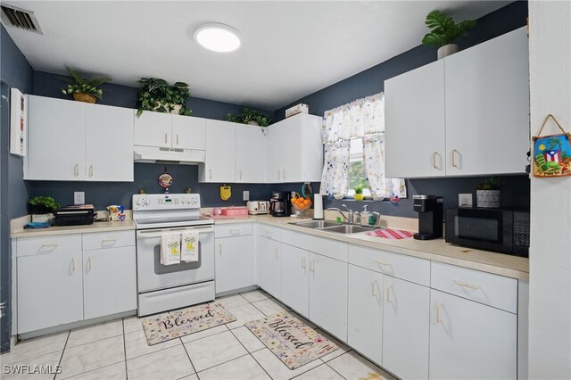 kitchen featuring under cabinet range hood, electric range, light countertops, and black microwave