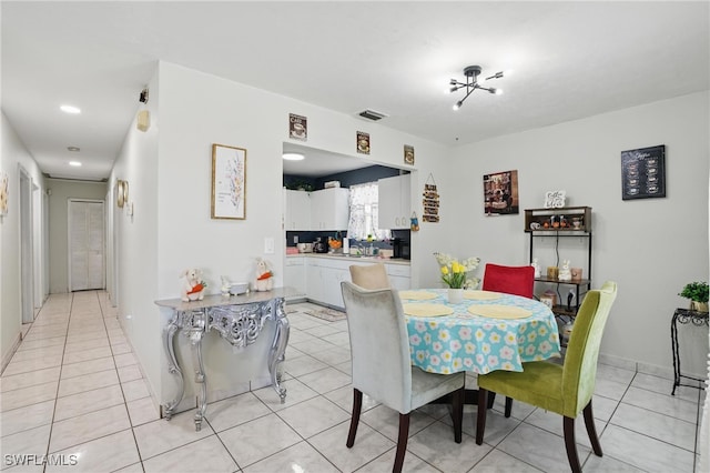 dining area with light tile patterned floors and visible vents