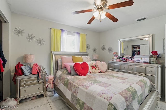 tiled bedroom with a ceiling fan and visible vents