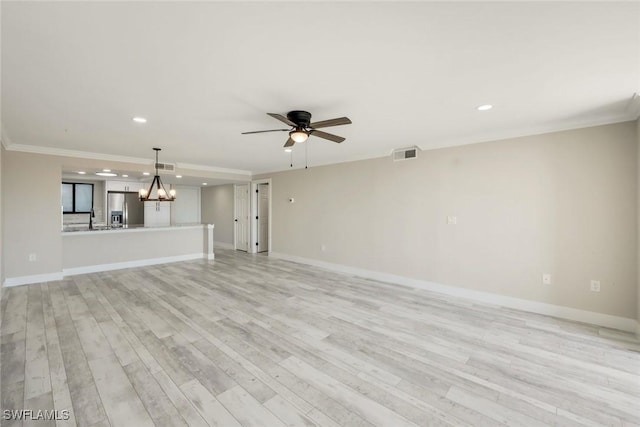 unfurnished living room featuring visible vents, light wood-style flooring, ceiling fan with notable chandelier, crown molding, and baseboards