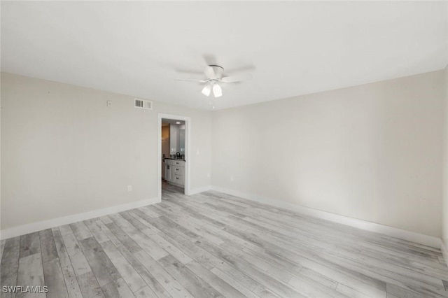 empty room with visible vents, baseboards, a ceiling fan, and light wood finished floors