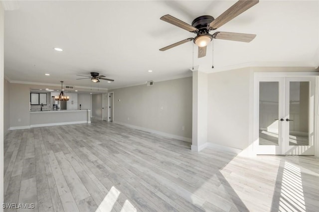 unfurnished living room featuring recessed lighting, ceiling fan with notable chandelier, light wood-style floors, and ornamental molding