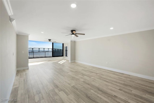 unfurnished room with recessed lighting, baseboards, light wood-type flooring, and ornamental molding