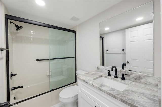 full bathroom with vanity, visible vents, recessed lighting, toilet, and combined bath / shower with glass door