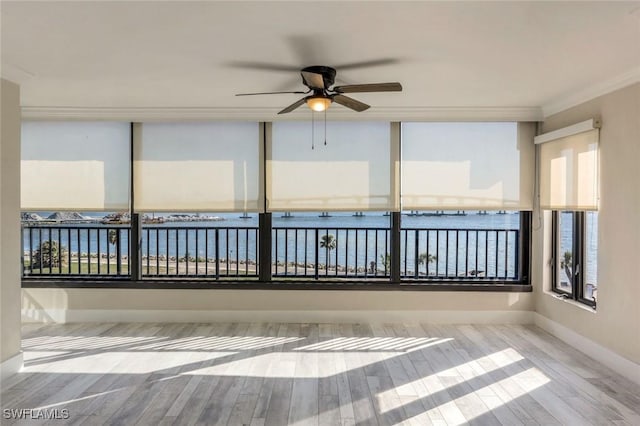 unfurnished sunroom with ceiling fan