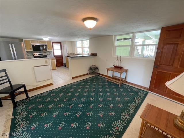 5460 Oak Ridge Ave, Fort Myers Beach, FL 33931 - living area with light tile patterned flooring, baseboards, and a textured ceiling