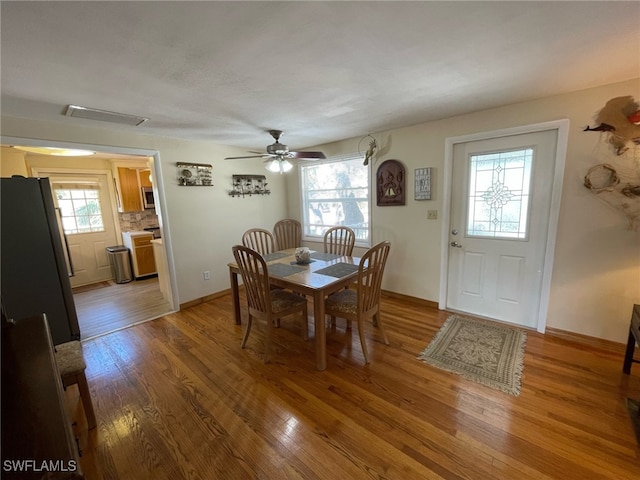 5460 Oak Ridge Ave, Fort Myers Beach, FL 33931 - dining area featuring baseboards, visible vents, light wood-style flooring, and a ceiling fan