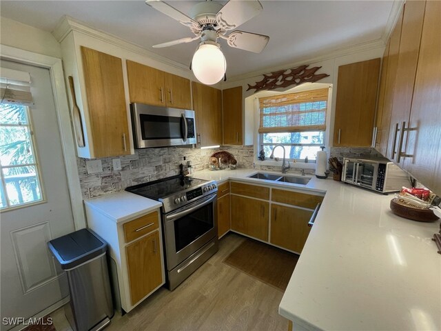 5460 Oak Ridge Ave, Fort Myers Beach, FL 33931 - kitchen with decorative backsplash, light countertops, a sink, and stainless steel appliances