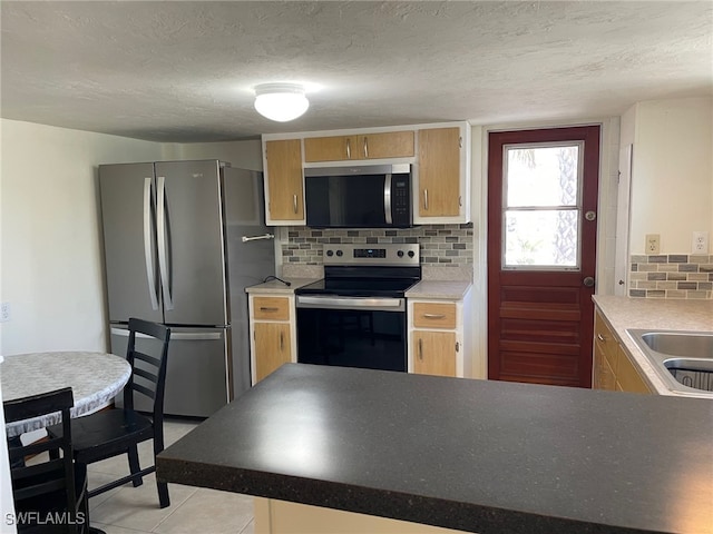 5460 Oak Ridge Ave, Fort Myers Beach, FL 33931 - kitchen featuring a sink, decorative backsplash, appliances with stainless steel finishes, and a textured ceiling