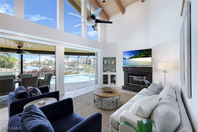 living area with tile patterned flooring, wooden ceiling, ceiling fan, and a high end fireplace