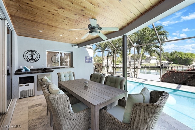 exterior space featuring a lanai, outdoor dining area, a ceiling fan, and an outdoor pool