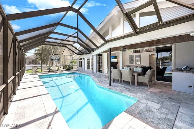 outdoor pool featuring glass enclosure, an outdoor living space, a patio area, and ceiling fan