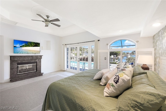 carpeted bedroom with a fireplace, access to outside, french doors, and ceiling fan