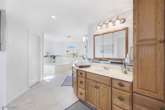 bathroom featuring tile patterned floors, visible vents, a bath, and vanity