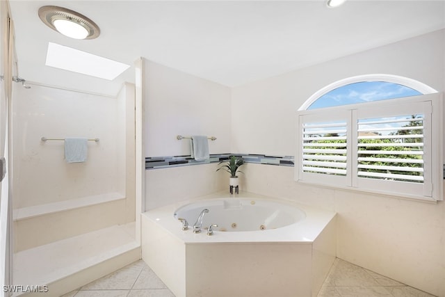 bathroom with tile patterned floors, a shower, and a tub with jets