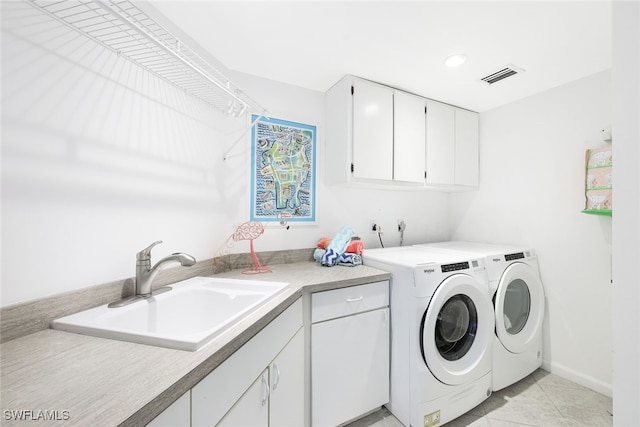 laundry room with visible vents, a sink, cabinet space, separate washer and dryer, and baseboards