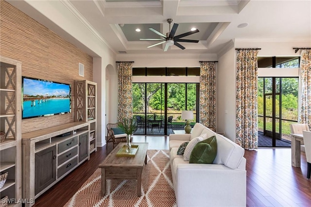 living area featuring ceiling fan, dark wood-type flooring, coffered ceiling, and ornamental molding