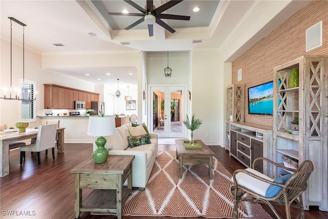 living area with dark wood-type flooring, ceiling fan with notable chandelier, recessed lighting, french doors, and crown molding