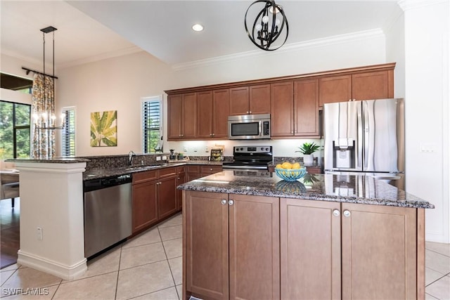 kitchen featuring stainless steel appliances, an inviting chandelier, ornamental molding, and dark stone counters