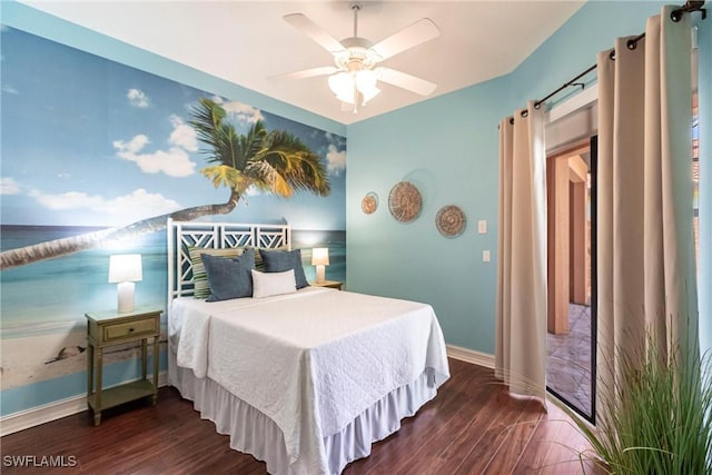 bedroom featuring wood finished floors, baseboards, and ceiling fan