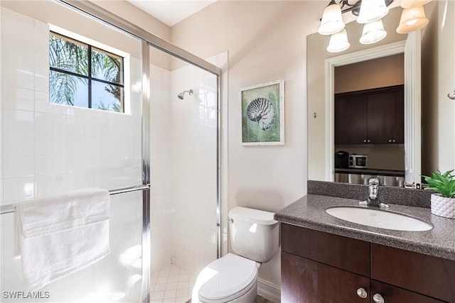 bathroom featuring vanity, toilet, a chandelier, and a shower stall