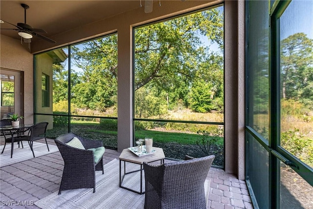 sunroom with a ceiling fan