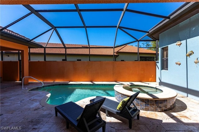 view of pool with a patio, a lanai, and a pool with connected hot tub