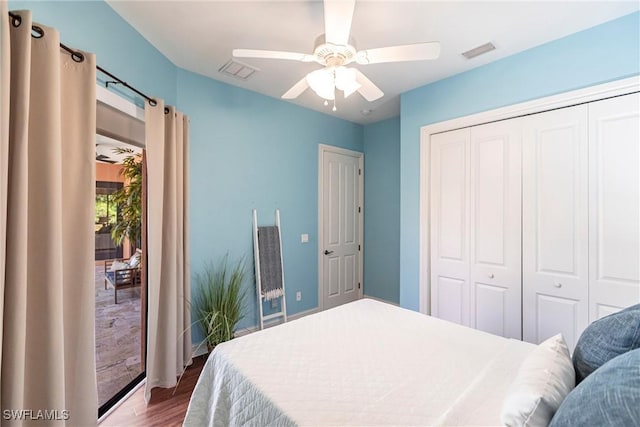 bedroom featuring a closet, visible vents, a ceiling fan, and wood finished floors