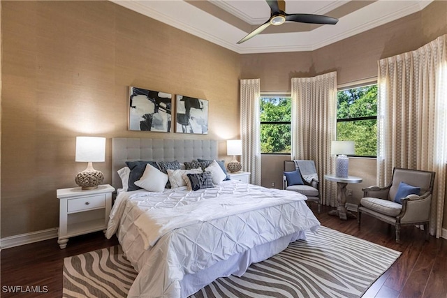 bedroom featuring a ceiling fan, crown molding, wood finished floors, and baseboards