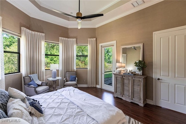 bedroom featuring dark wood-style floors, visible vents, baseboards, access to exterior, and a raised ceiling