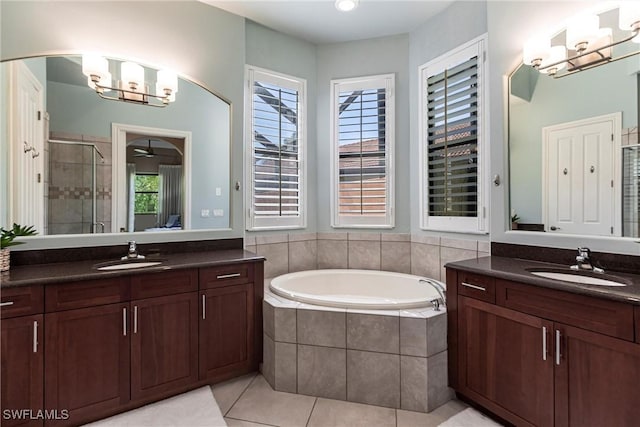 full bathroom featuring a bath, a stall shower, an inviting chandelier, and a sink