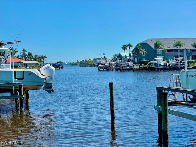 4703 SE 17th Pl Unit 105, Cape Coral, FL 33904 - dock area featuring boat lift and a water view