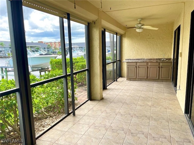 4703 SE 17th Pl Unit 105, Cape Coral, FL 33904 - unfurnished sunroom featuring a textured wall
